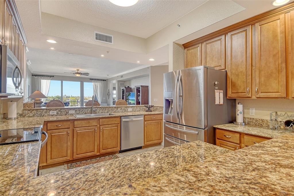 5100 Jessie Harbor Drive, Unit 504 Osprey, FL 34229 - Photo 25 of 87 a kitchen with stainless steel appliances granite countertop a refrigerator sink and cabinets