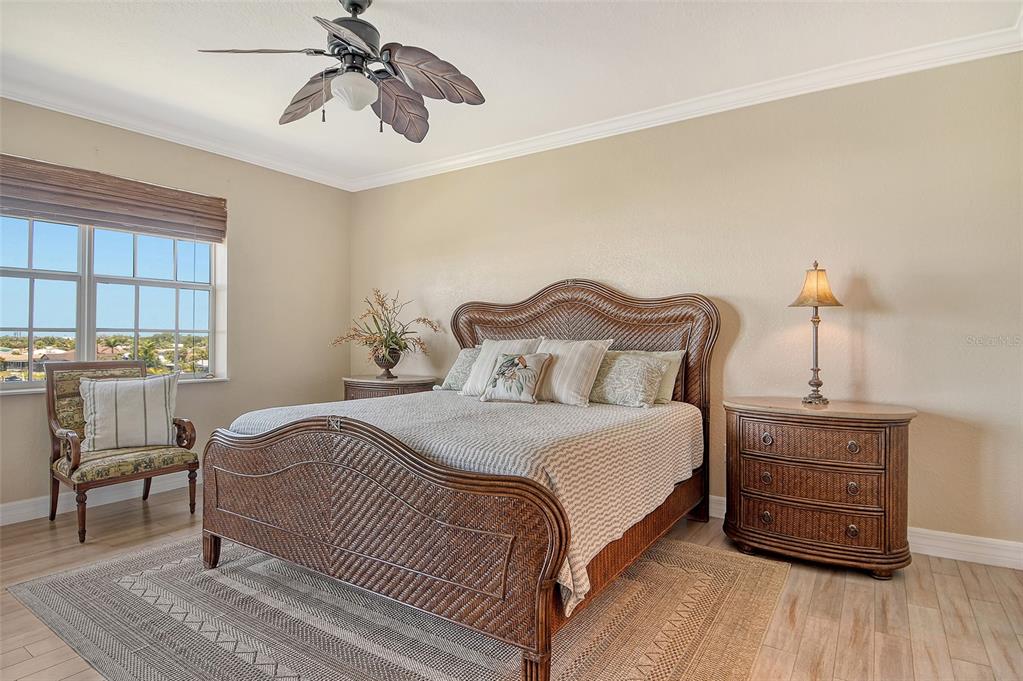 5100 Jessie Harbor Drive, Unit 504 Osprey, FL 34229 - Photo 30 of 87 a bedroom with a bed and wooden floor