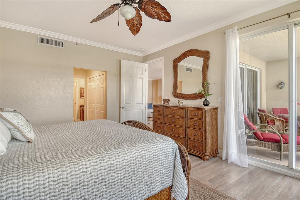 5100 Jessie Harbor Drive, Unit 504 Osprey, FL 34229 - Photo 32 of 87 a bedroom with a bed and a mirror