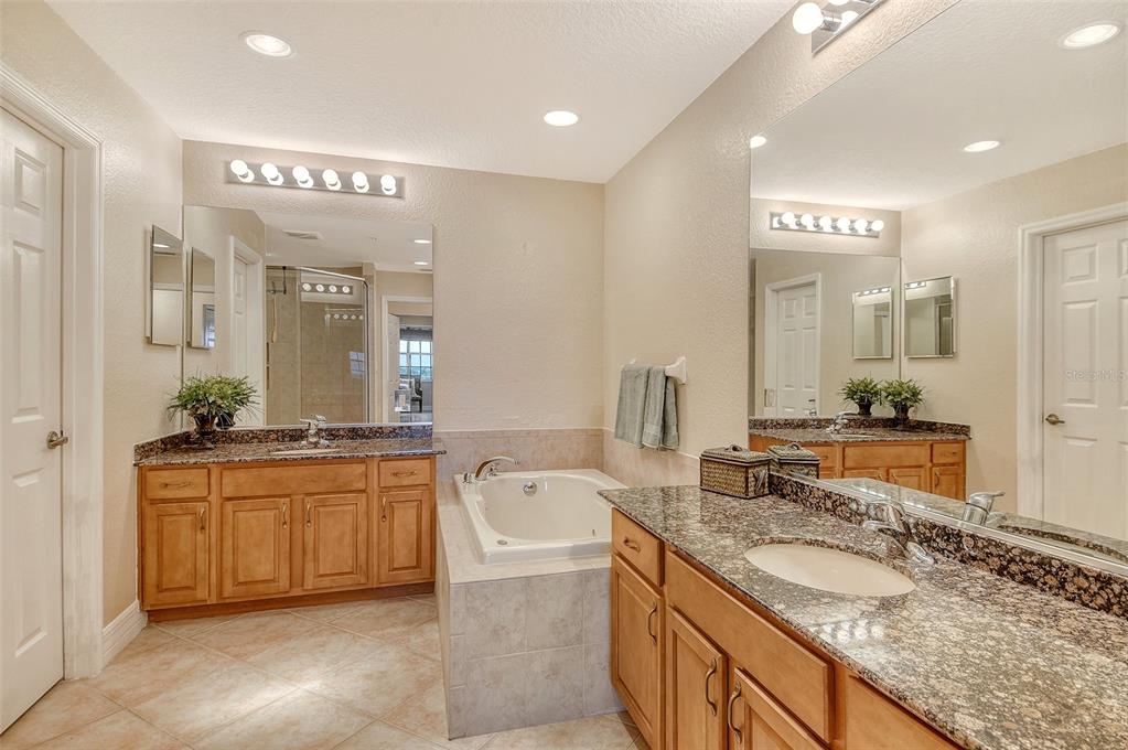 5100 Jessie Harbor Drive, Unit 504 Osprey, FL 34229 - Photo 34 of 87 a bathroom with a granite countertop double vanity sink and a mirror