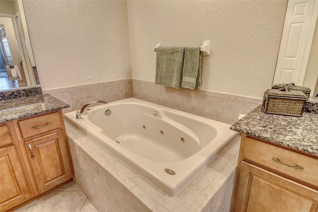 5100 Jessie Harbor Drive, Unit 504 Osprey, FL 34229 - Photo 35 of 87 a bathroom with a tub sink and mirror