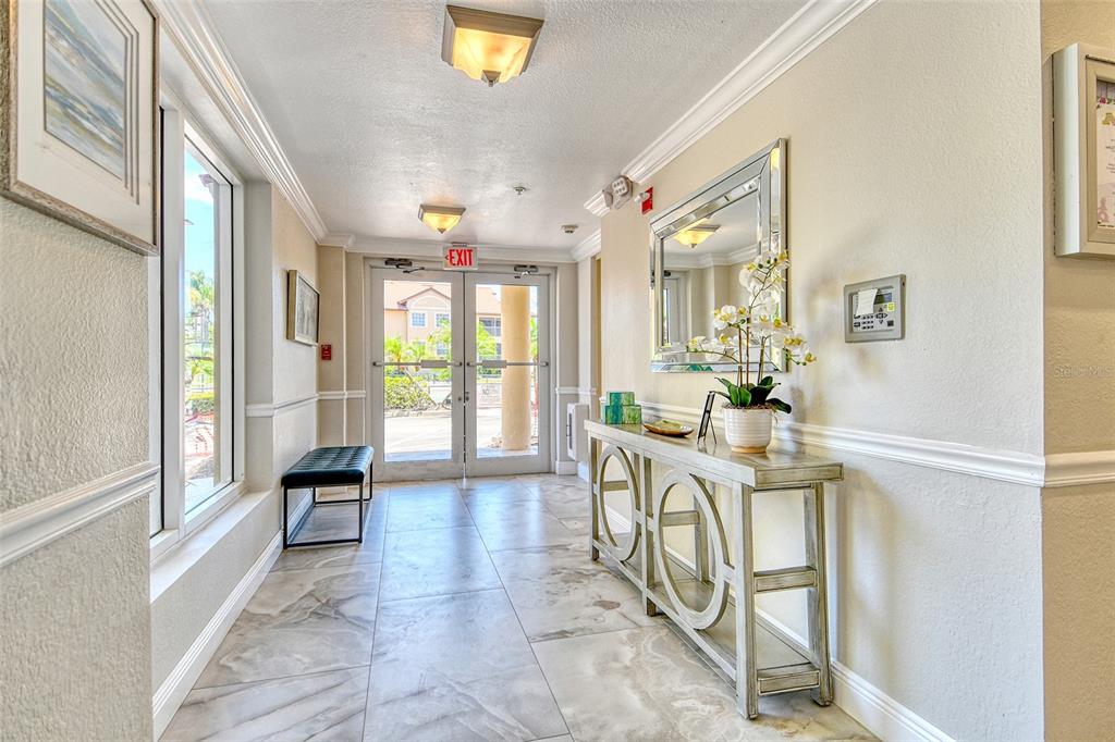 5100 Jessie Harbor Drive, Unit 504 Osprey, FL 34229 - Photo 4 of 87 a view of a hallway with furniture and a chandelier
