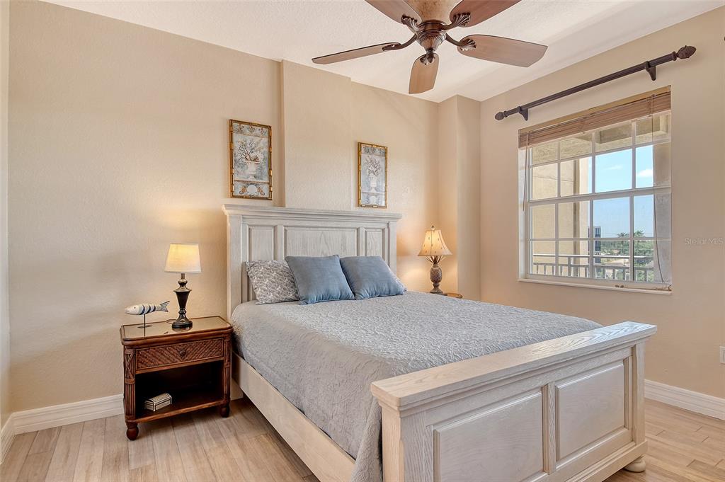 5100 Jessie Harbor Drive, Unit 504 Osprey, FL 34229 - Photo 41 of 87 a bedroom with a bed and a chandelier