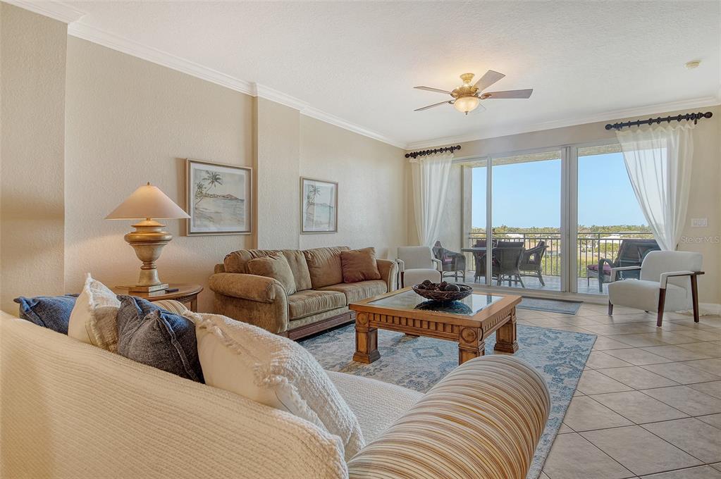 5100 Jessie Harbor Drive, Unit 504 Osprey, FL 34229 - Photo 8 of 87 a living room with furniture and a large window