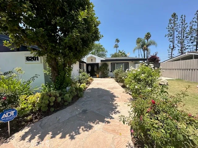a view of a house with a yard and garden