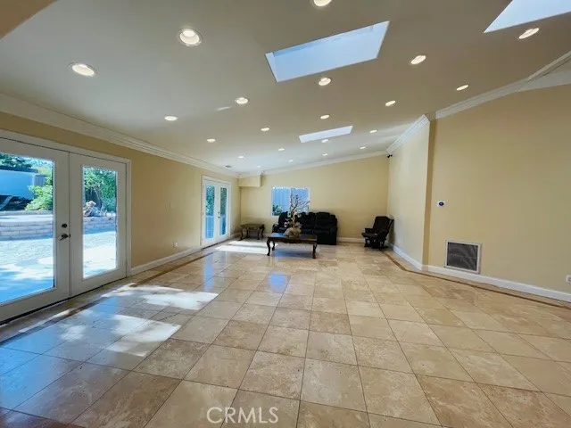 a kitchen with stainless steel appliances a dining table and chairs in it