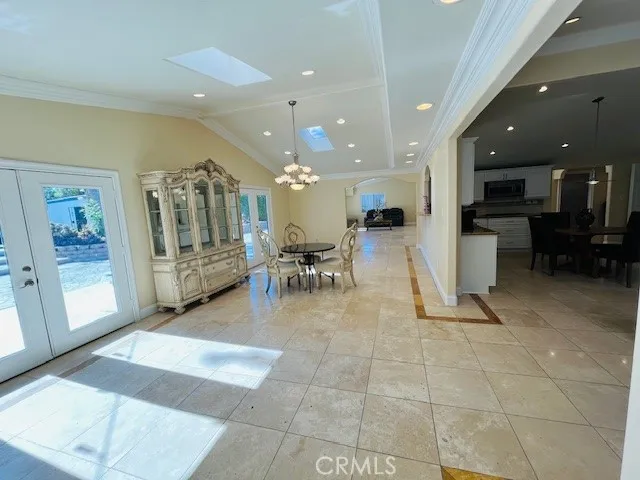 a kitchen with a sink white cabinets and stainless steel appliances