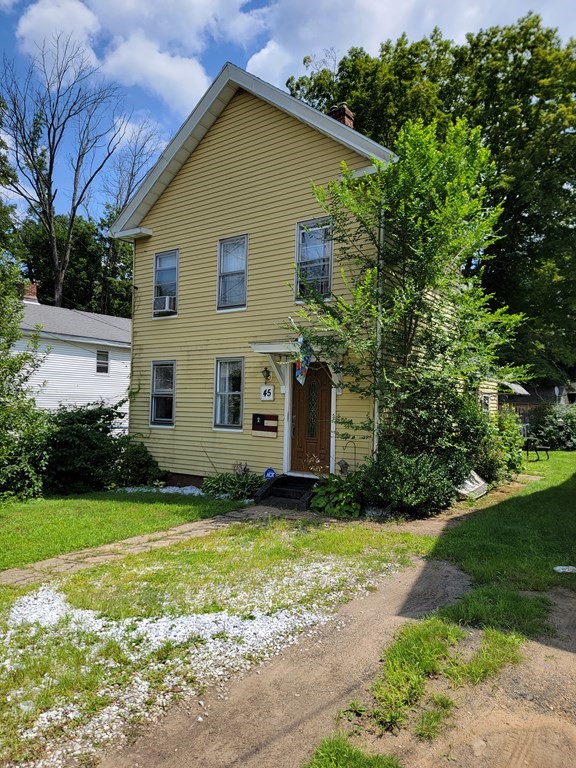 a view of a house with yard and a garden