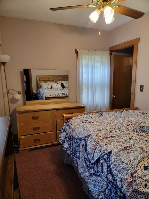 45 Maple Street Warren, MA 01083 - Photo 12 of 20 a bedroom with a bed and a chandelier