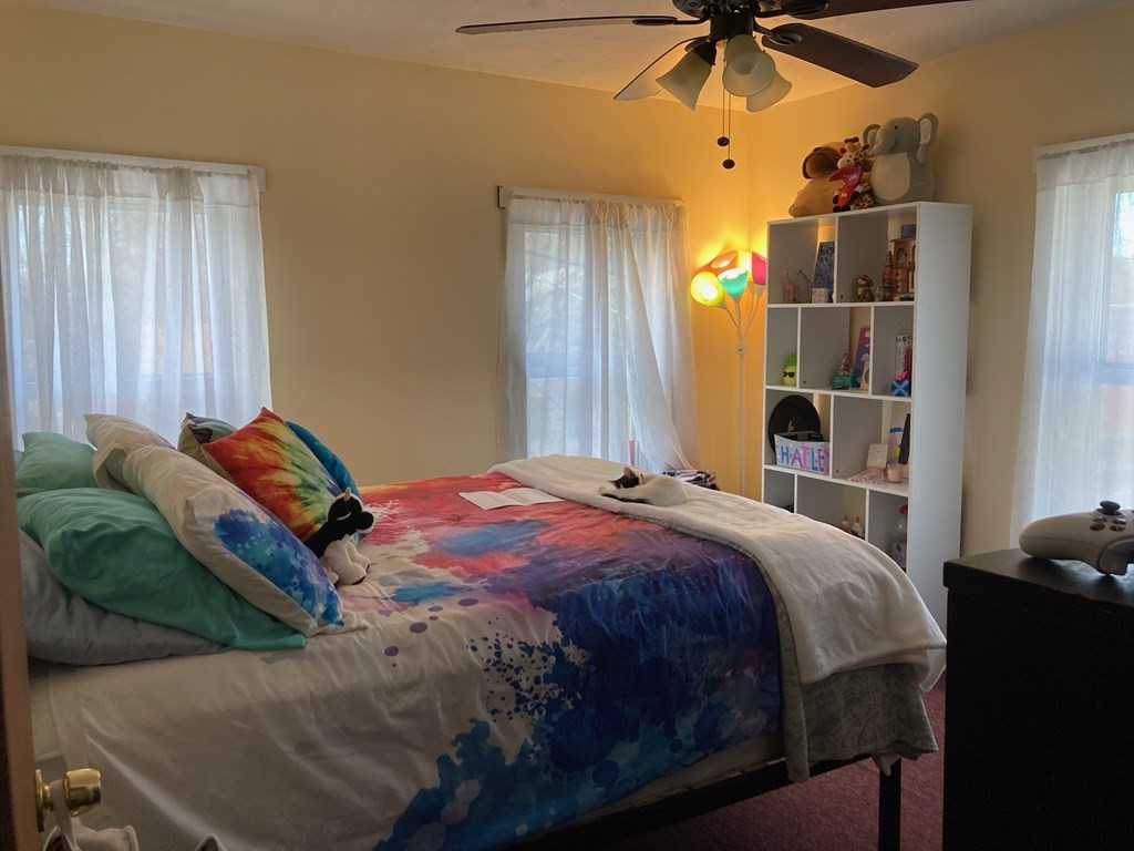 45 Maple Street Warren, MA 01083 - Photo 15 of 20 a bedroom with a bed and a chandelier