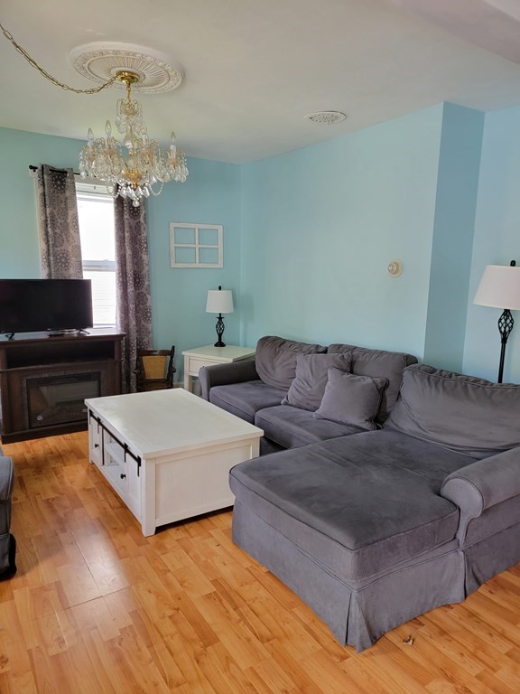 45 Maple Street Warren, MA 01083 - Photo 3 of 20 a living room with furniture and a chandelier