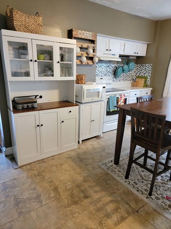 45 Maple Street Warren, MA 01083 - Photo 9 of 20 a kitchen with stainless steel appliances granite countertop a stove a sink and white cabinets