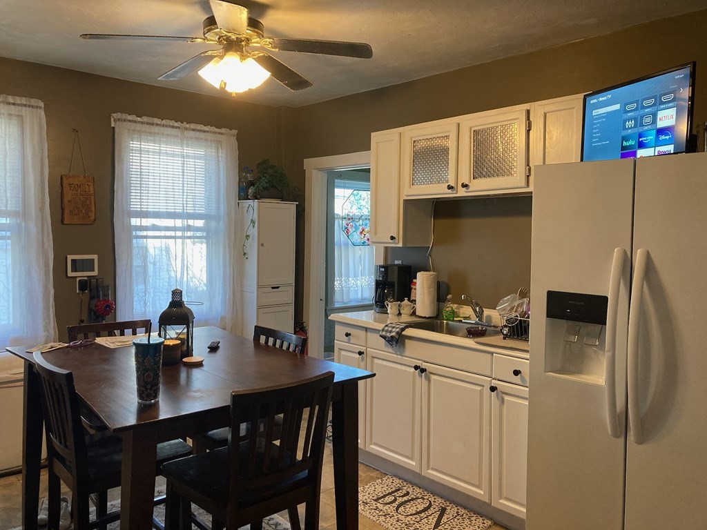 45 Maple Street Warren, MA 01083 - Photo 10 of 20 a kitchen with stainless steel appliances a table chairs and a refrigerator