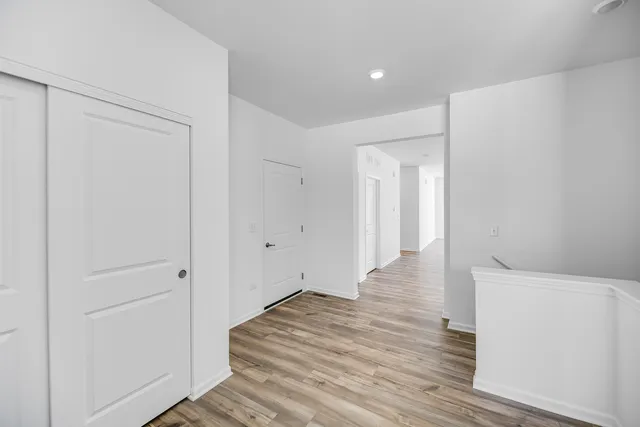 a view of a hallway with wooden floor