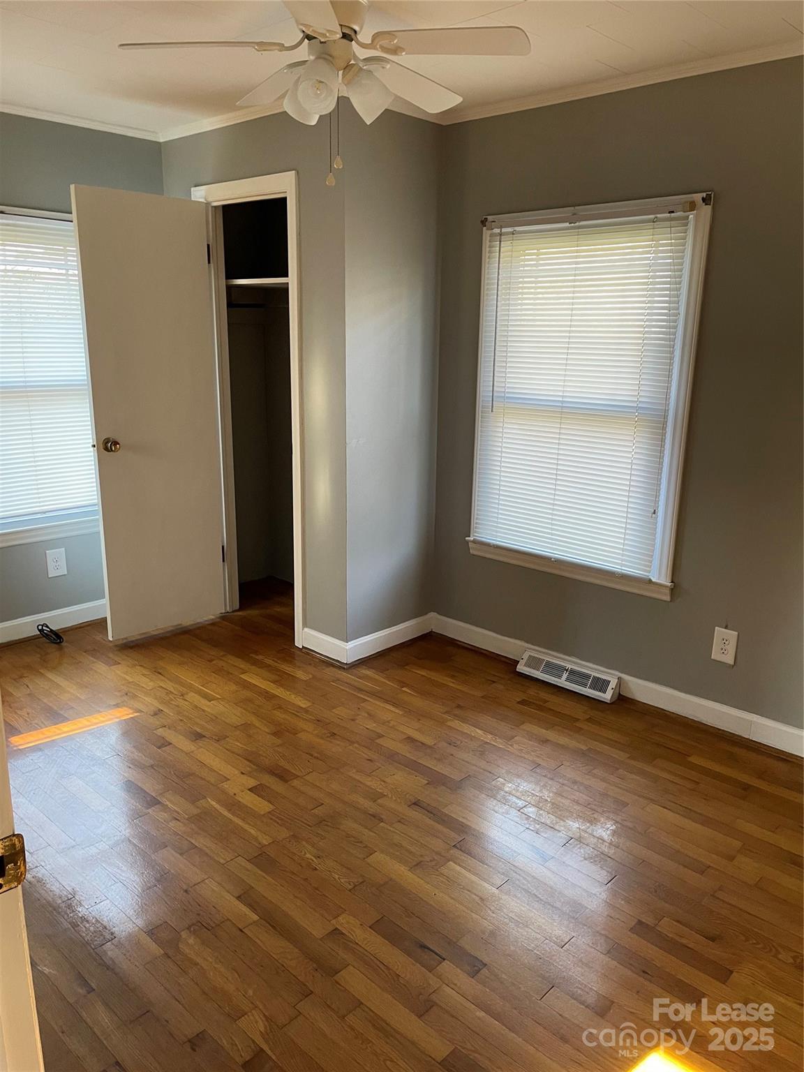 118 Peach Orchard Road Belmont, NC 28012 - Photo 2 of 4 an empty room with wooden floor and windows