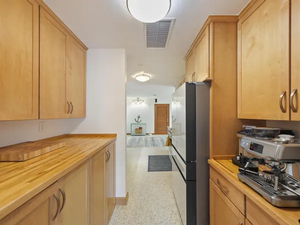 a kitchen with stainless steel appliances granite countertop a refrigerator and a stove