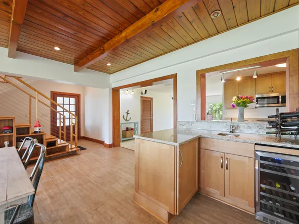 a living room with furniture a flat screen tv and large window