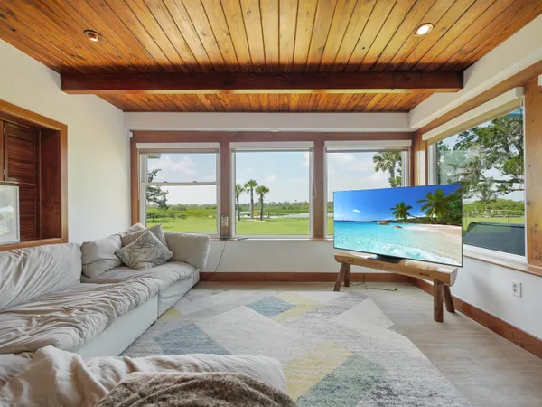a living room with furniture a large window with outer view