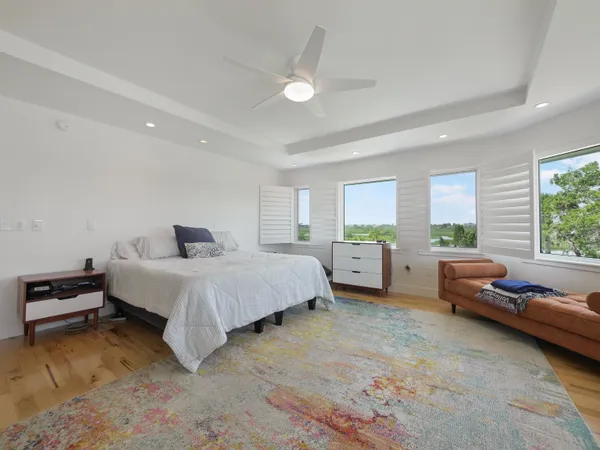 a spacious bedroom with a bed and a couch