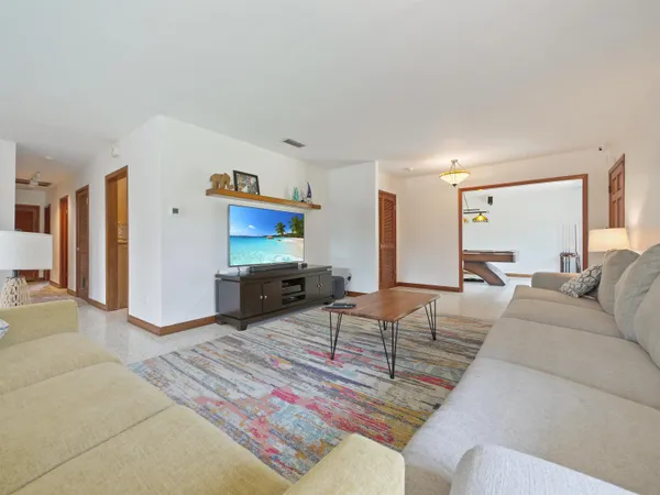 a living room with furniture and a flat screen tv