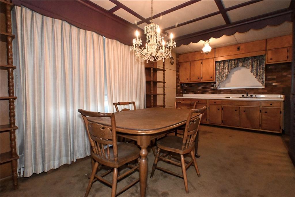 Crystal chandelier, bulk-head around the windows, full cabinets.