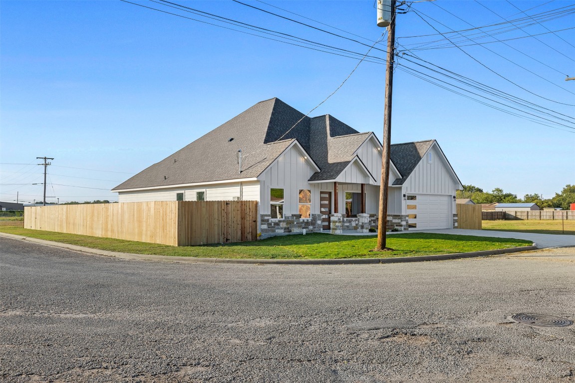 340 Cactus Street Giddings, TX 78942 - Photo 2 of 37 View of front facade featuring a shingled roof, board and batten siding, and driveway