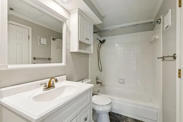 a bathroom with a sink mirror toilet and bathtub