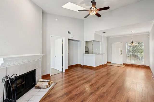 a view of empty room with wooden floor and fireplace