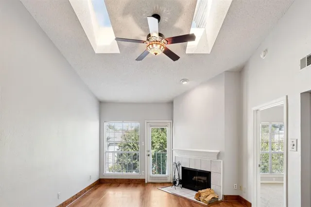 a view of empty room with fireplace and window