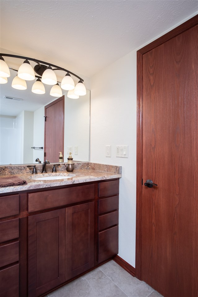 6350 Blomberg Road Cherry Valley, IL 61016 - Photo 17 of 25 a bathroom with a granite countertop sink and a mirror