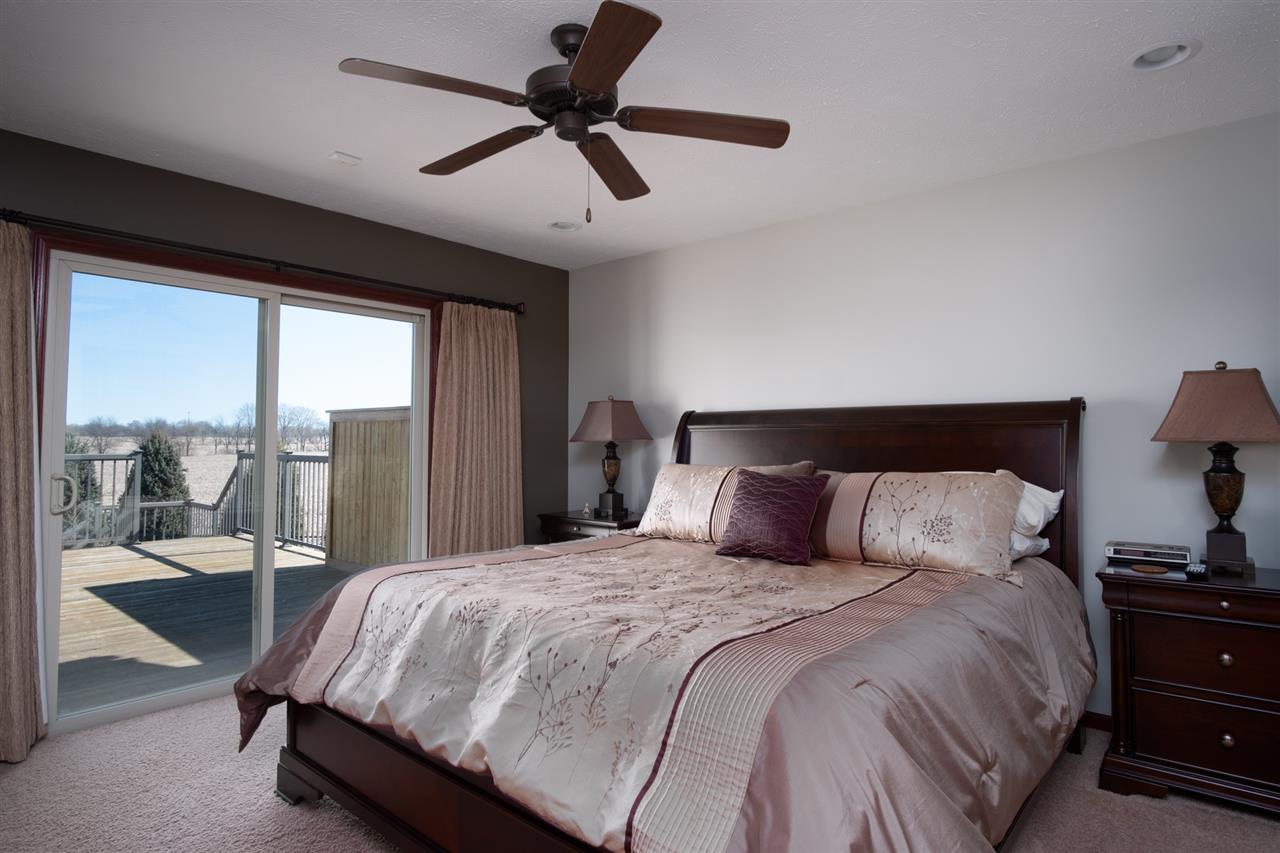 6350 Blomberg Road Cherry Valley, IL 61016 - Photo 8 of 25 a bedroom with a bed and glass walk in closet