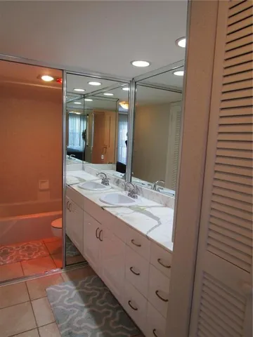 a bathroom with a double vanity sink and a mirror