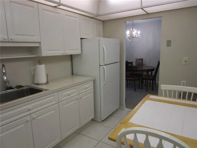 a kitchen with refrigerator and cabinets