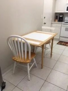 a dining room with furniture and a kitchen view