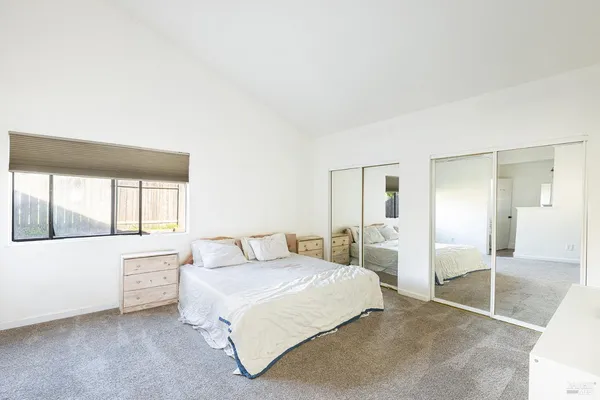 a bedroom with a large bed and a large window