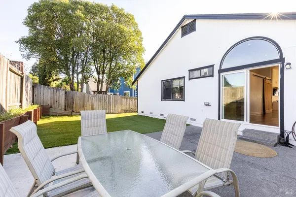 a view of backyard with outdoor seating and green space