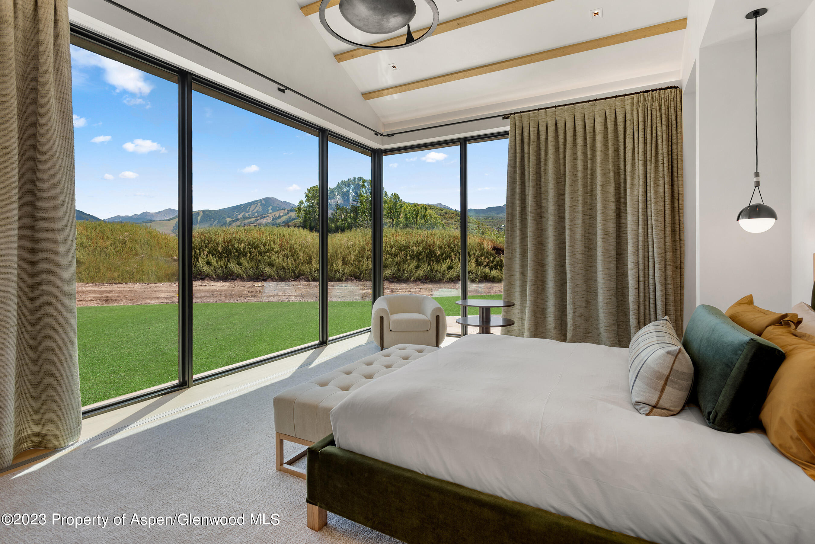 245 Slalom Path Aspen, CO 81612 - Photo 16 of 34 a bedroom with a large bed and a large window