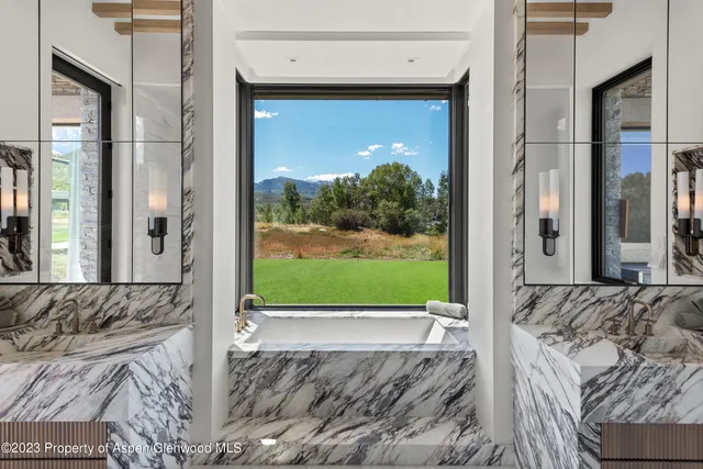 a view of a bedroom with a bed and glass door