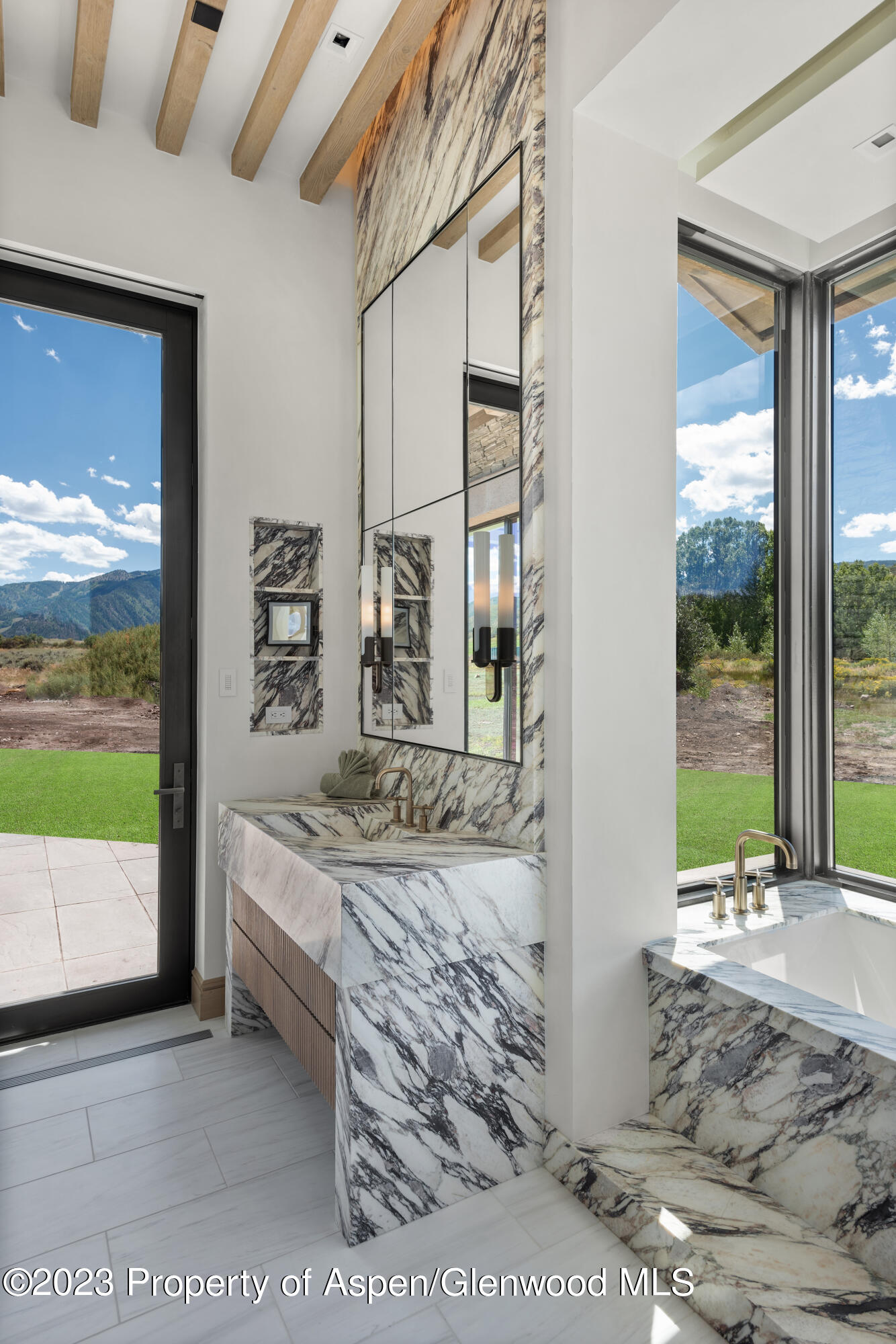 245 Slalom Path Aspen, CO 81612 - Photo 19 of 34 a bedroom with furniture and large window