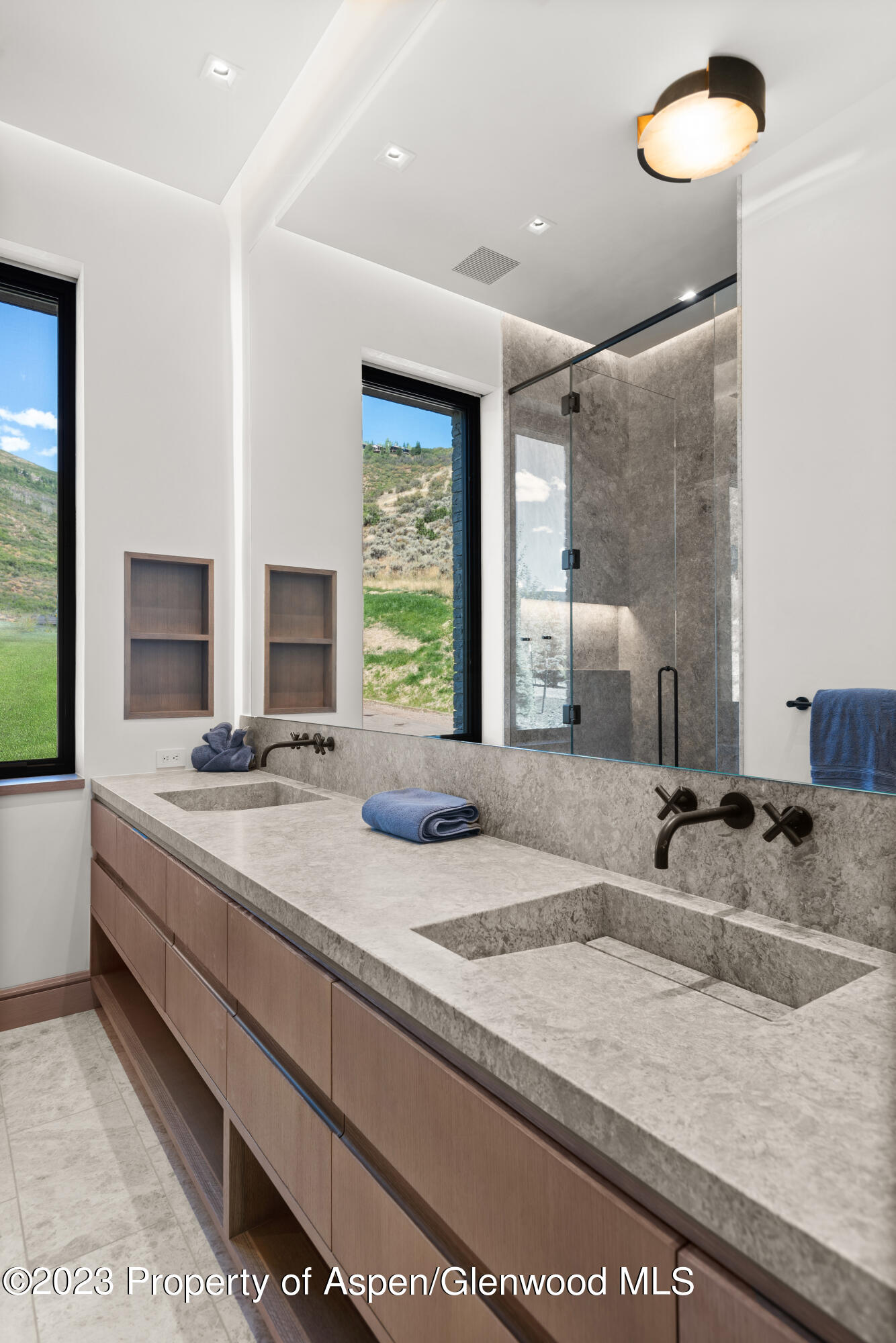 245 Slalom Path Aspen, CO 81612 - Photo 24 of 34 a bathroom with a granite countertop sink and a large mirror