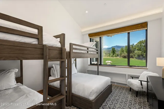 a bedroom with a bed and large window