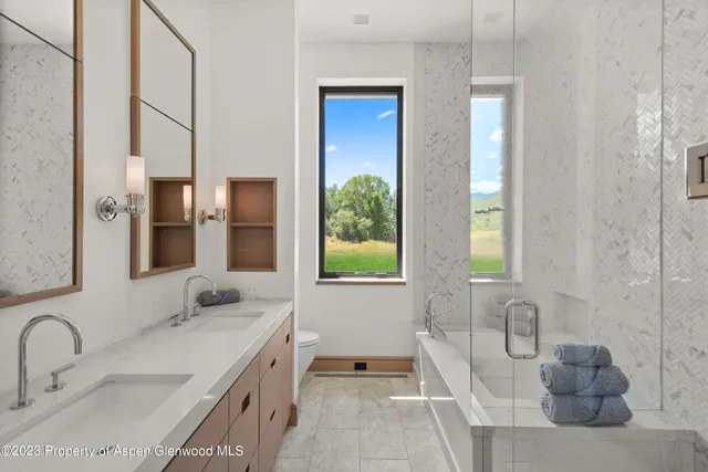 a spacious bathroom with a granite countertop tub sink and mirror