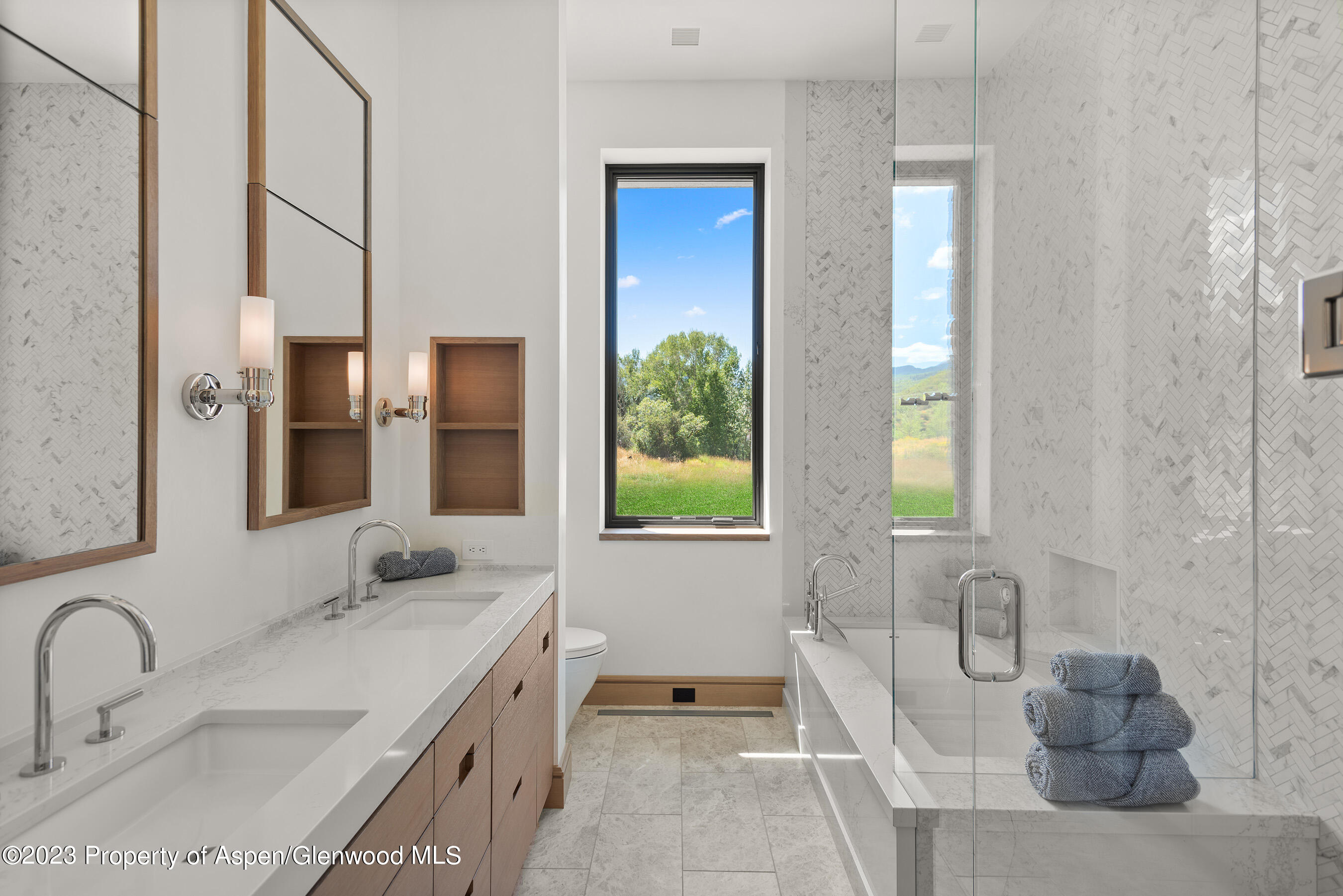 245 Slalom Path Aspen, CO 81612 - Photo 30 of 34 a spacious bathroom with a granite countertop tub sink and mirror