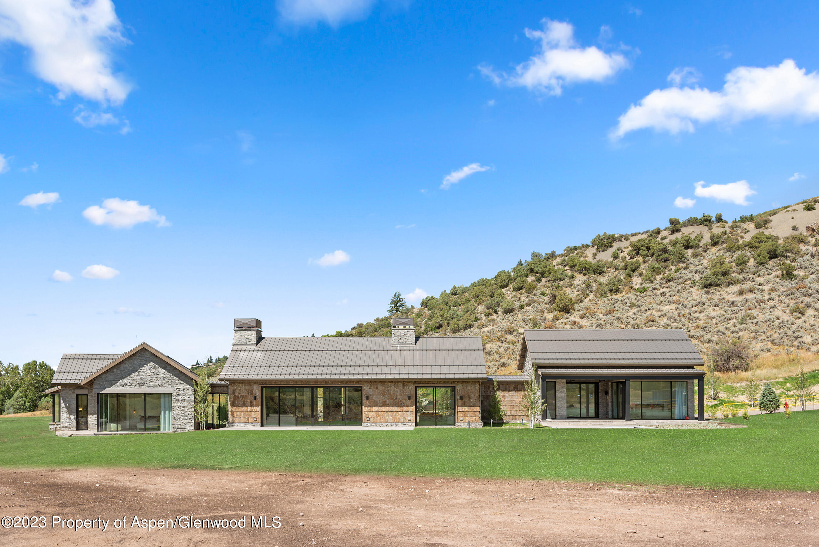 245 Slalom Path Aspen, CO 81612 - Photo 31 of 34 a front view of a house with a yard