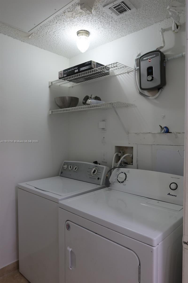 18340 Northwest 68th Avenue, Unit A Hialeah, FL 33015 - Photo 7 of 10 a utility room with dryer and washer