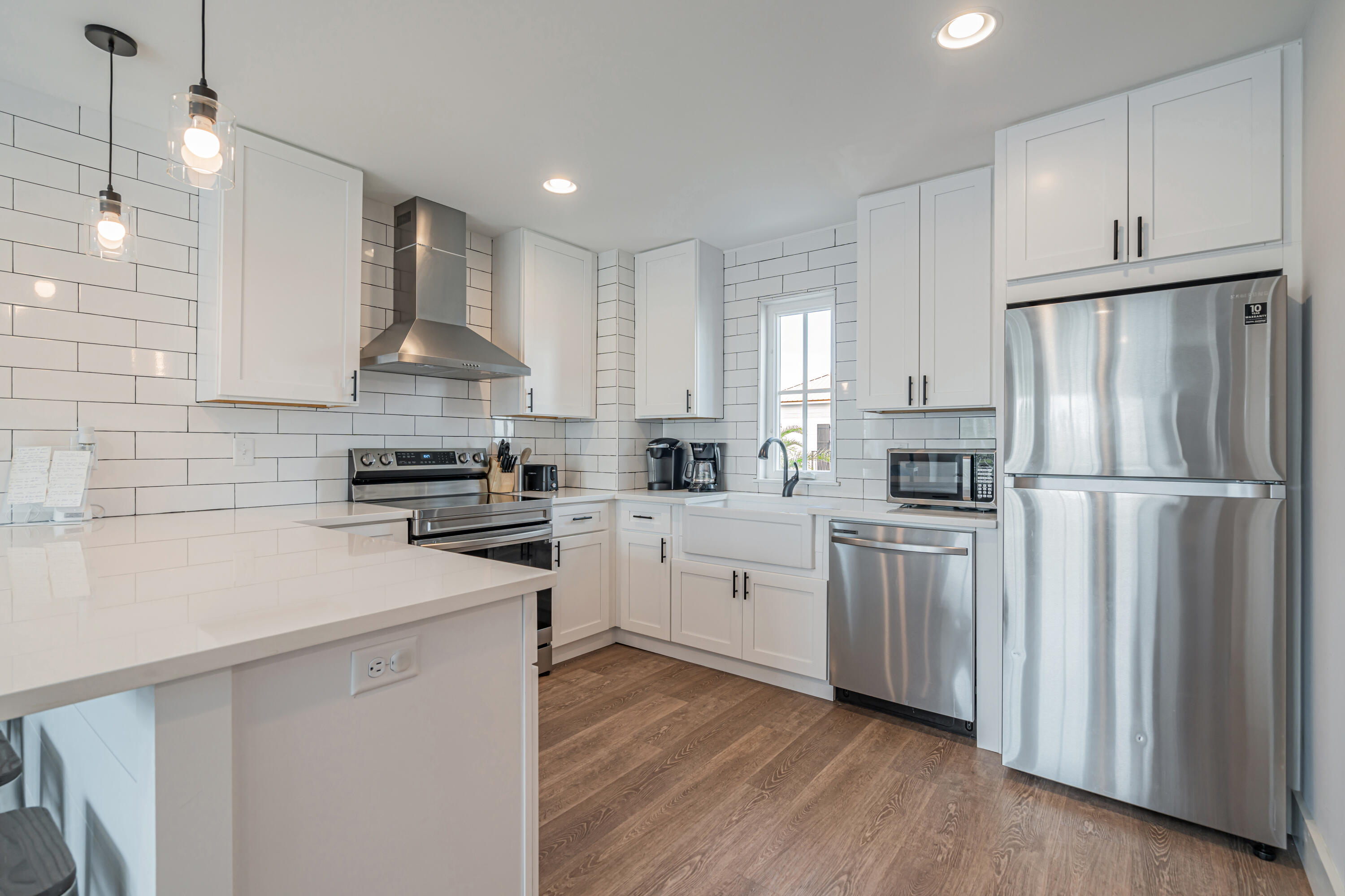 41 Abbie Road Santa Rosa Beach, FL 32459 - Photo 12 of 38 a kitchen with white cabinets and stainless steel appliances