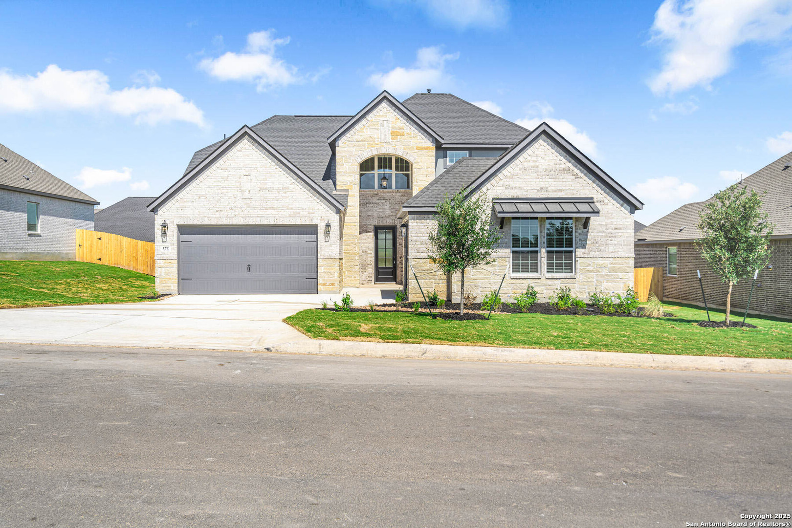 a front view of a house with a yard and garage
