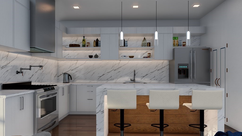 531 Main Street, Unit 2002 Reading, MA 01867 - Photo 4 of 7 a kitchen with stainless steel appliances kitchen island a stove and cabinets