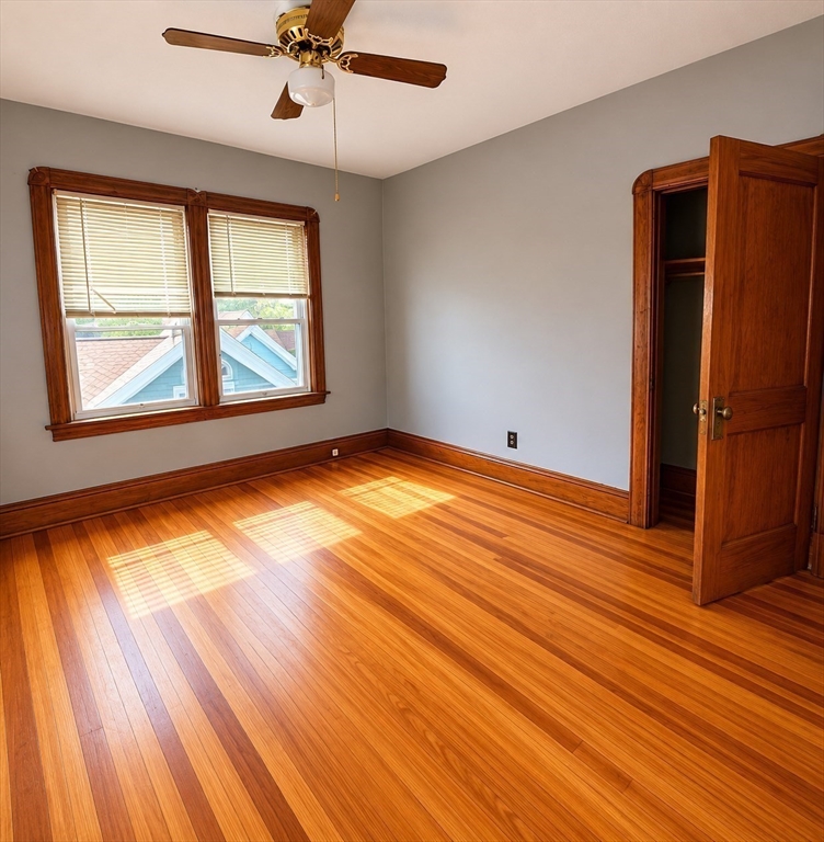 37 Shawmut Street Fall River, MA 02720 - Photo 12 of 16 an empty room with wooden floor and windows