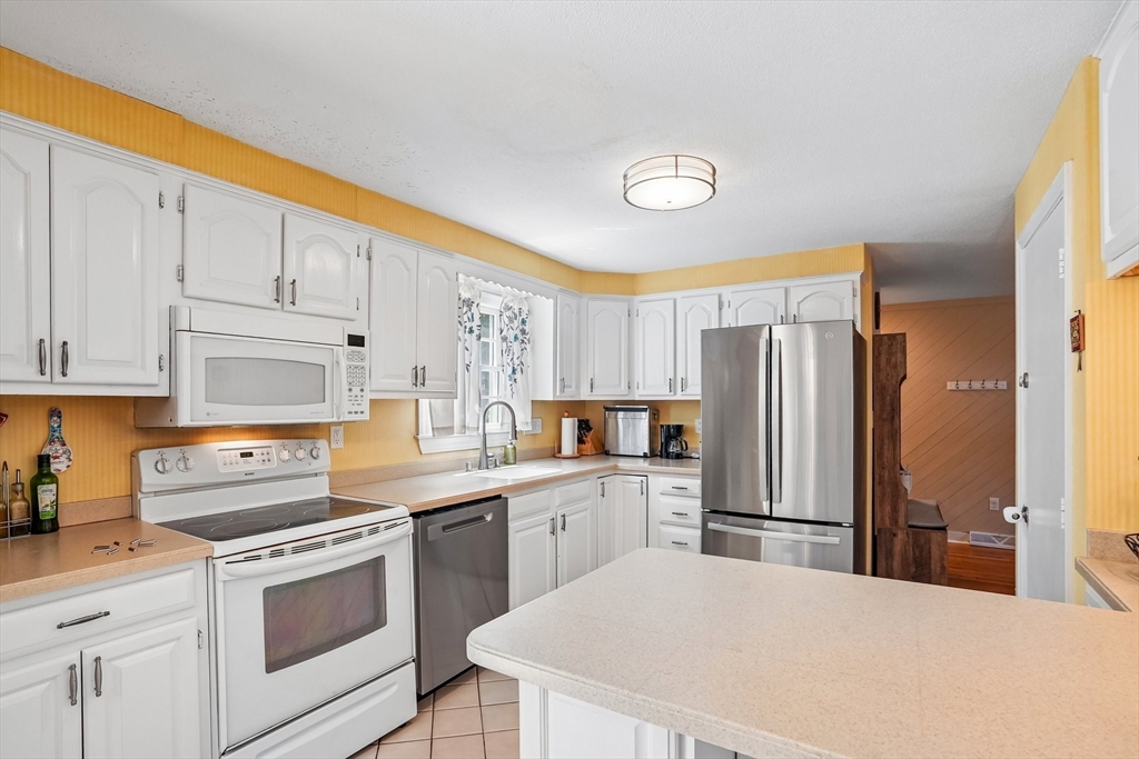 35 Westgate Road Framingham, MA 01701 - Photo 11 of 37 a kitchen with white cabinets and stainless steel appliances